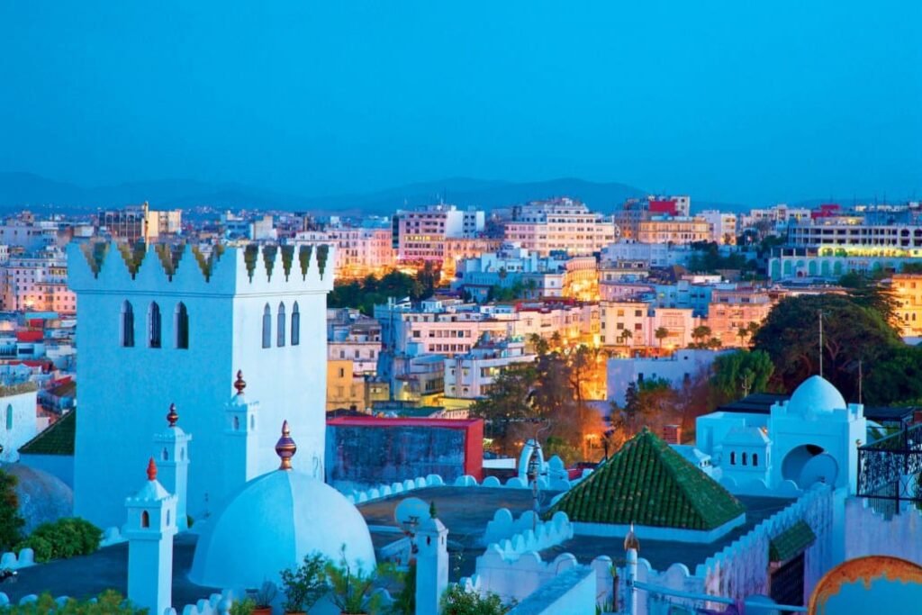 Tangier medina rooftops and minaret overlooking the bay at dusk