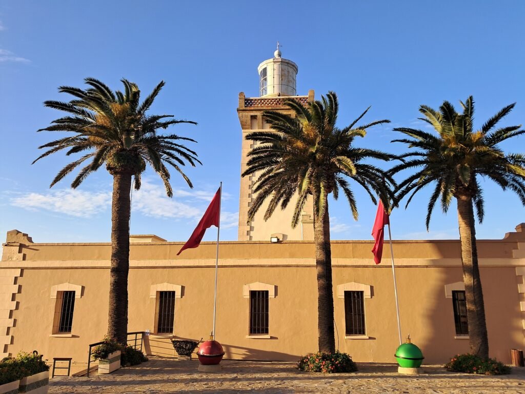 The Cape Spartel lighthouse seen between tall palm trees near Tangier