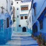 A blue alley with washing hanging between the houses of Chefchaouen