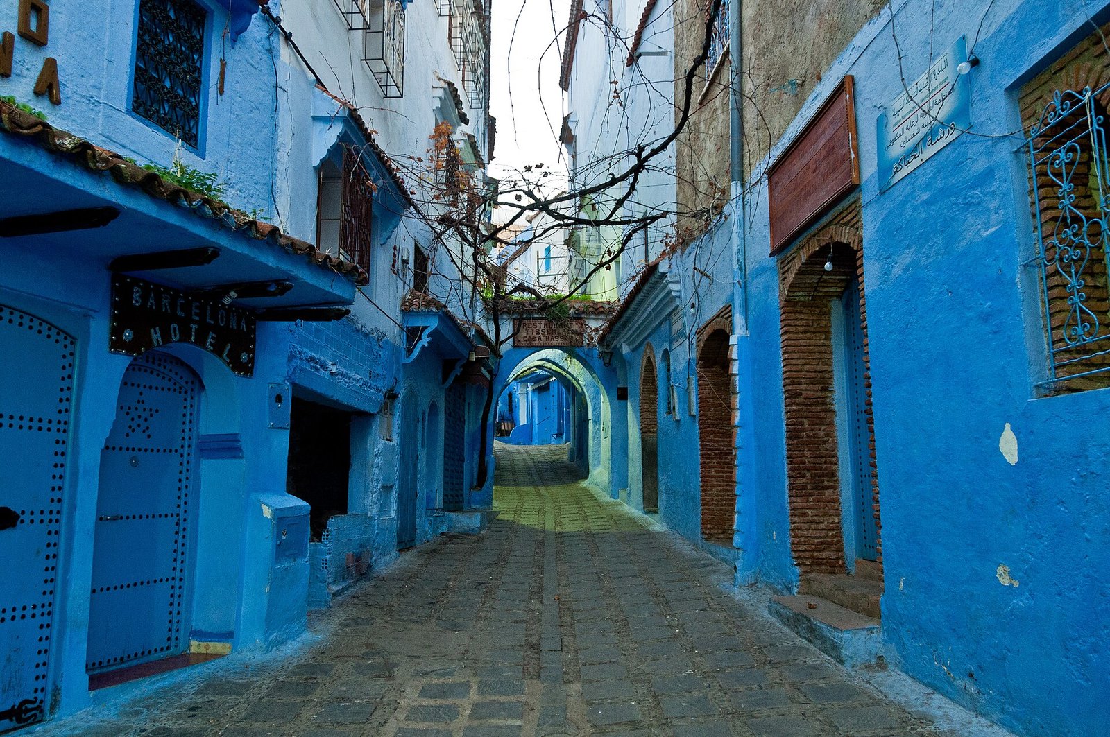 A blue street with painted doors in the medina of Chefchaouen
