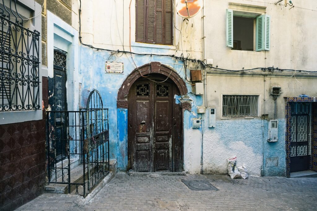 A blue door and a stone alley in the medina of Tangier in winter light