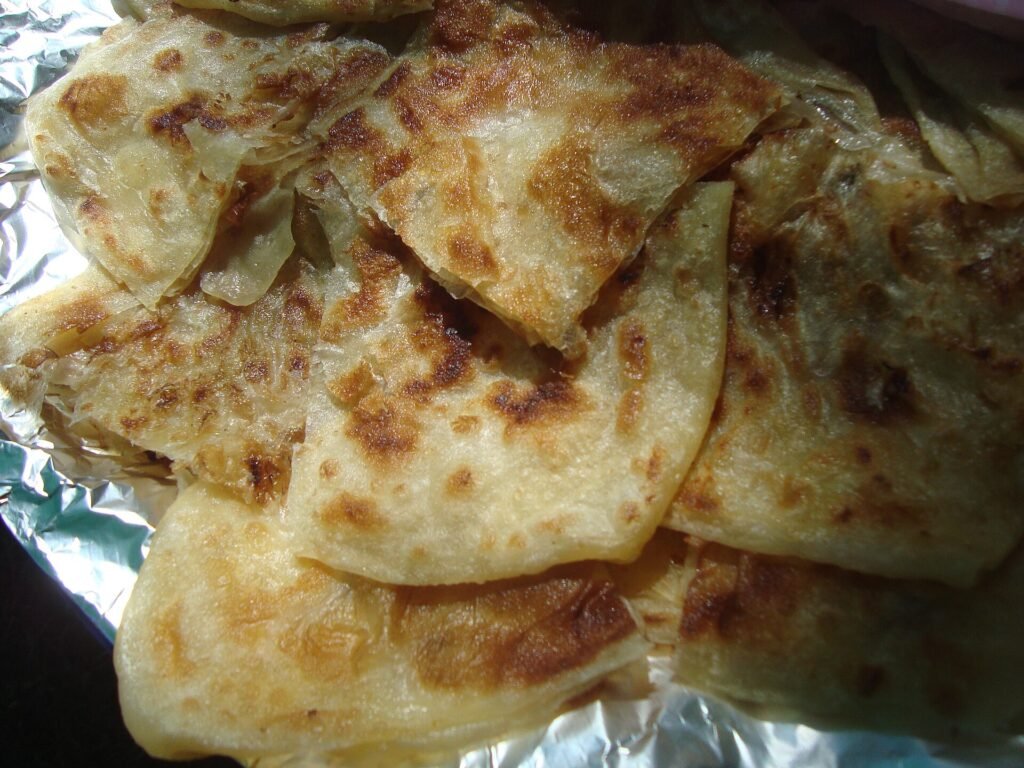 Golden msemmen flatbreads on a plate, a typical breakfast to try when you plan what to eat in Tangier