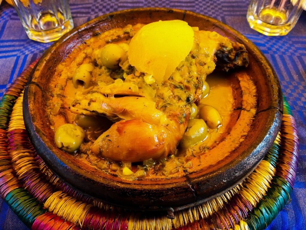 A chicken tagine with preserved lemon and olives in a clay dish