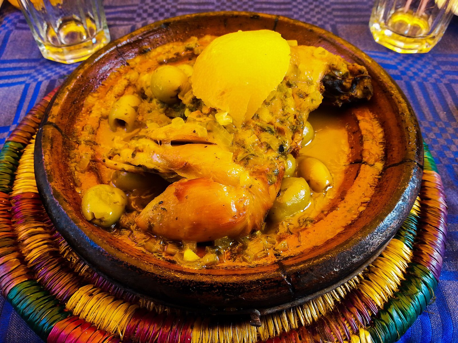 A chicken tagine with preserved lemon and olives in a clay dish