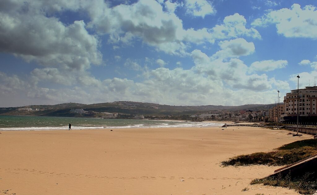 The long sandy beach of Tangier on a sunny day with clouds