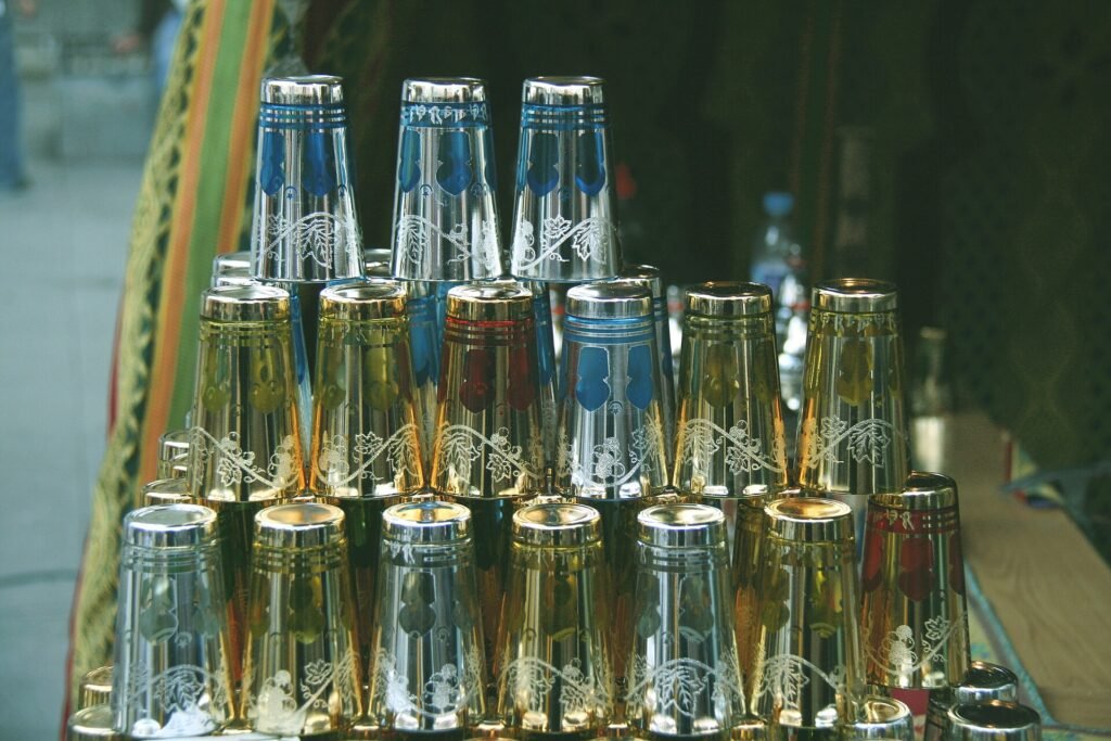 A pyramid of decorated Moroccan tea glasses in a souk